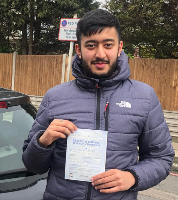 Happy driving student holding certificate after passing test with Admire Driving School